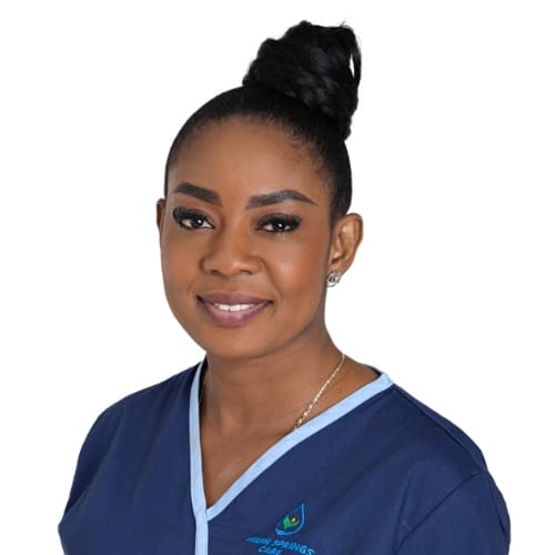 Grace Abutiate - Care Coordinator at Fresh Springs Care, supporting staff and clients with kindness. Grace Abutiate, Care Coordinator at Fresh Springs Care, smiling warmly in a professional setting.