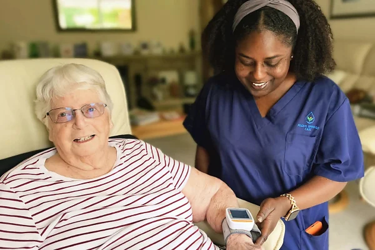 Fresh Springs Care carer checking an elderly woman's blood pressure at home in Bristol